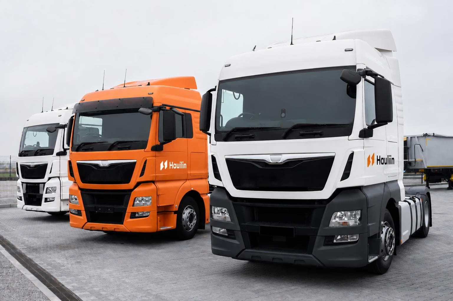 Hauliin-branded haulage trucks lined up at a depot