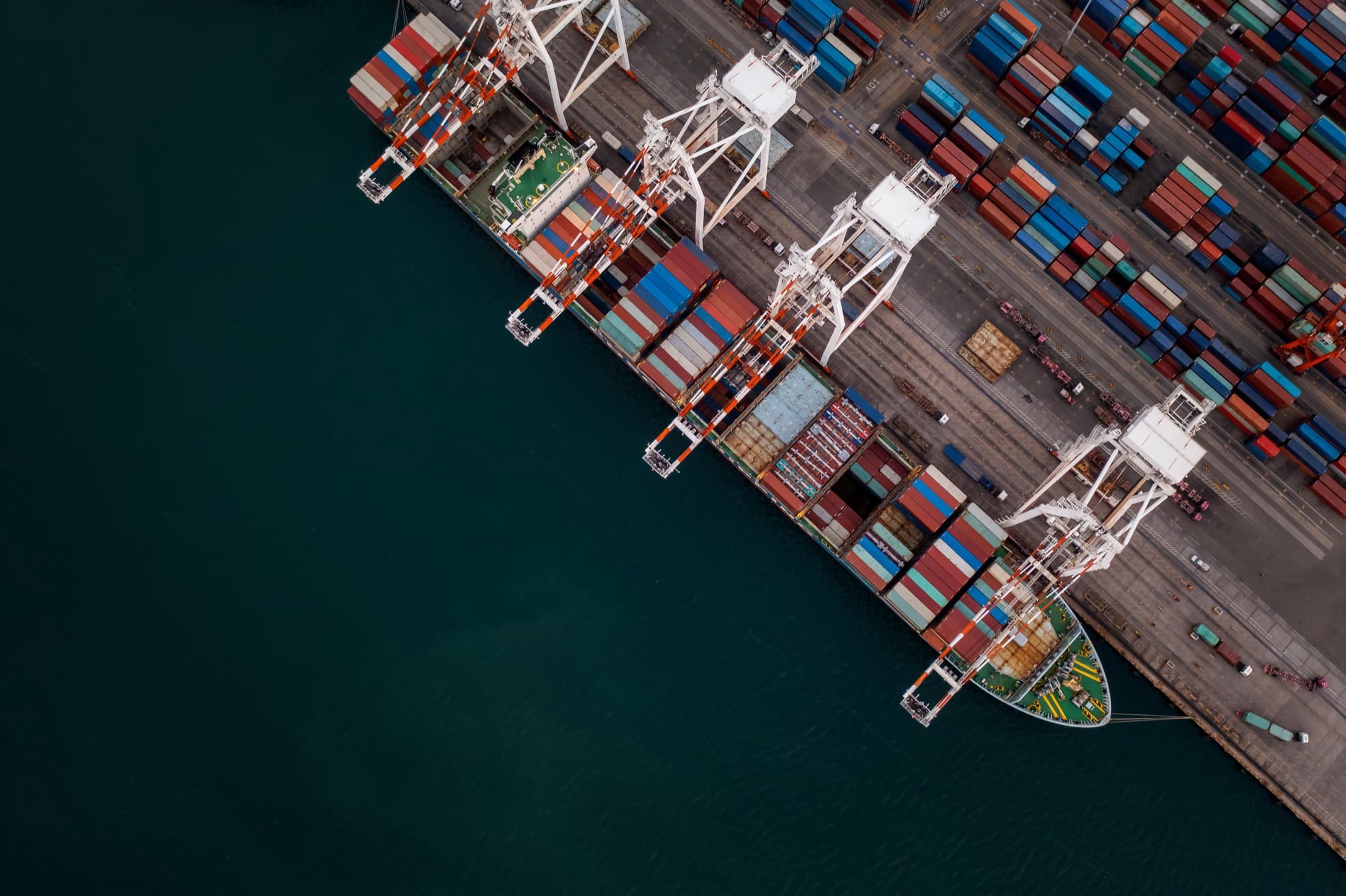 Aerial view of a container port being worked by cranes